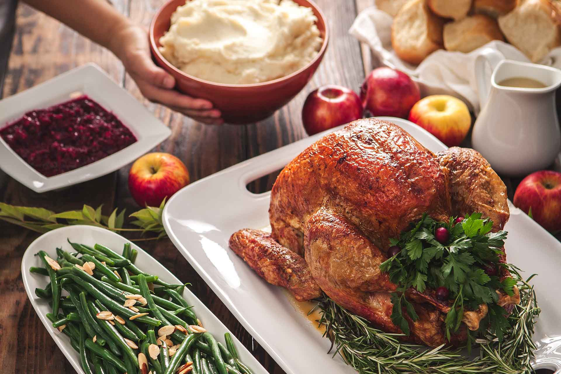 Woman serving a rosted turkey