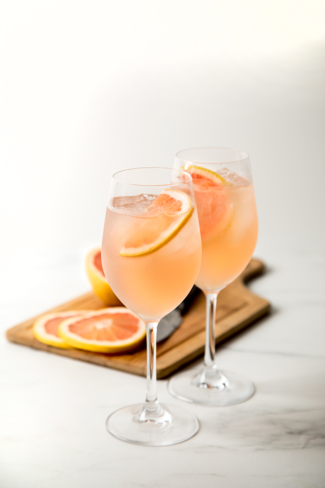 sparkling rose cocktail with grapefruit in the background