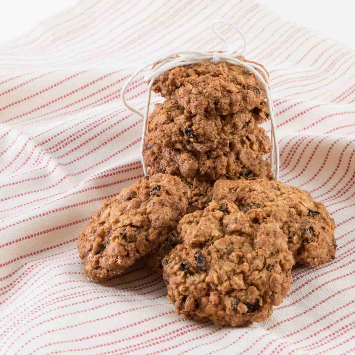 A stack of oatmeal cookies on a stripped napkin