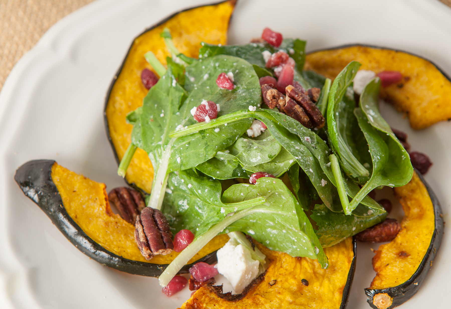 roasted acorn squash with greens and pomegranates