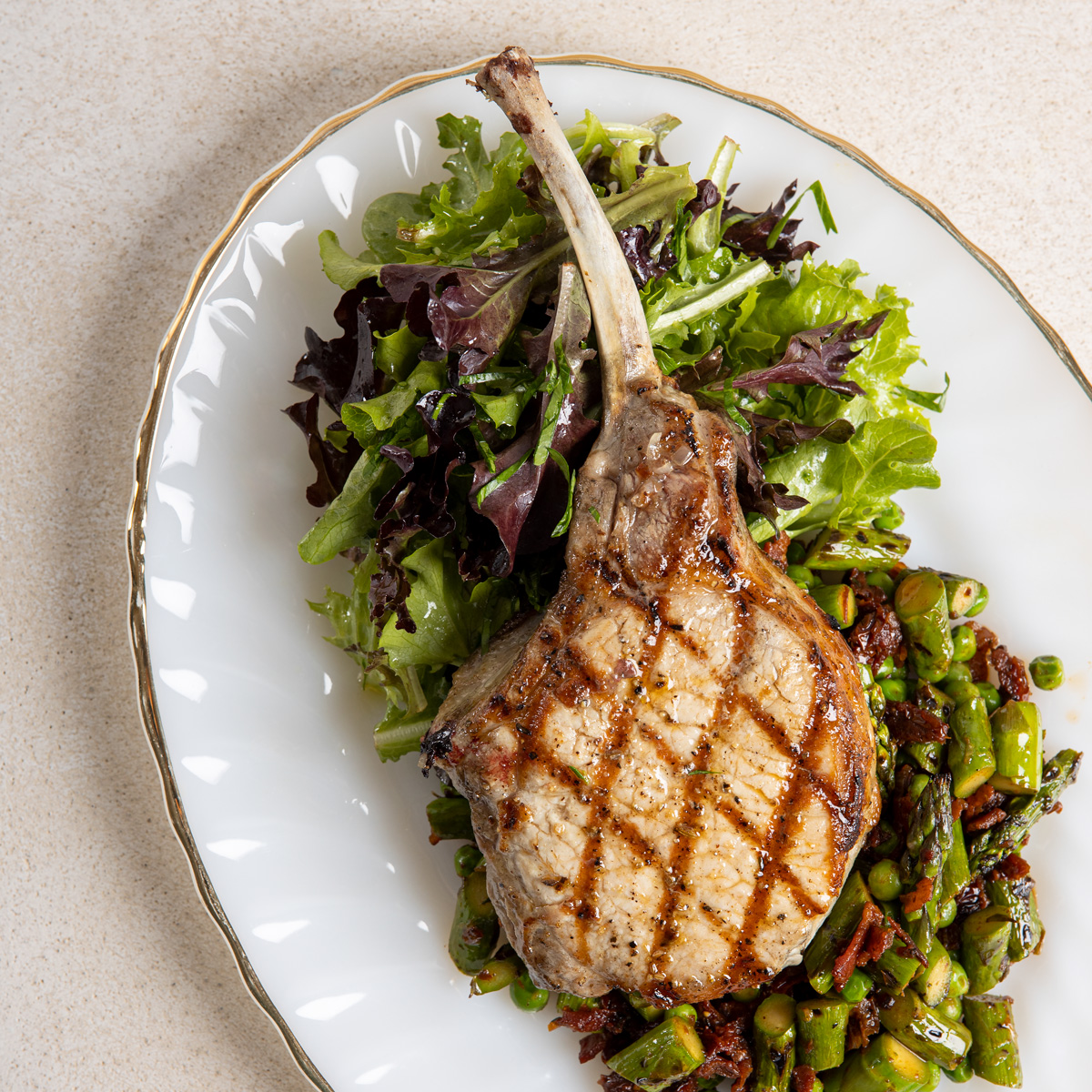 Grilled Tomahawk Pork Chops with Asparagus & Sun-Dried Tomatoes