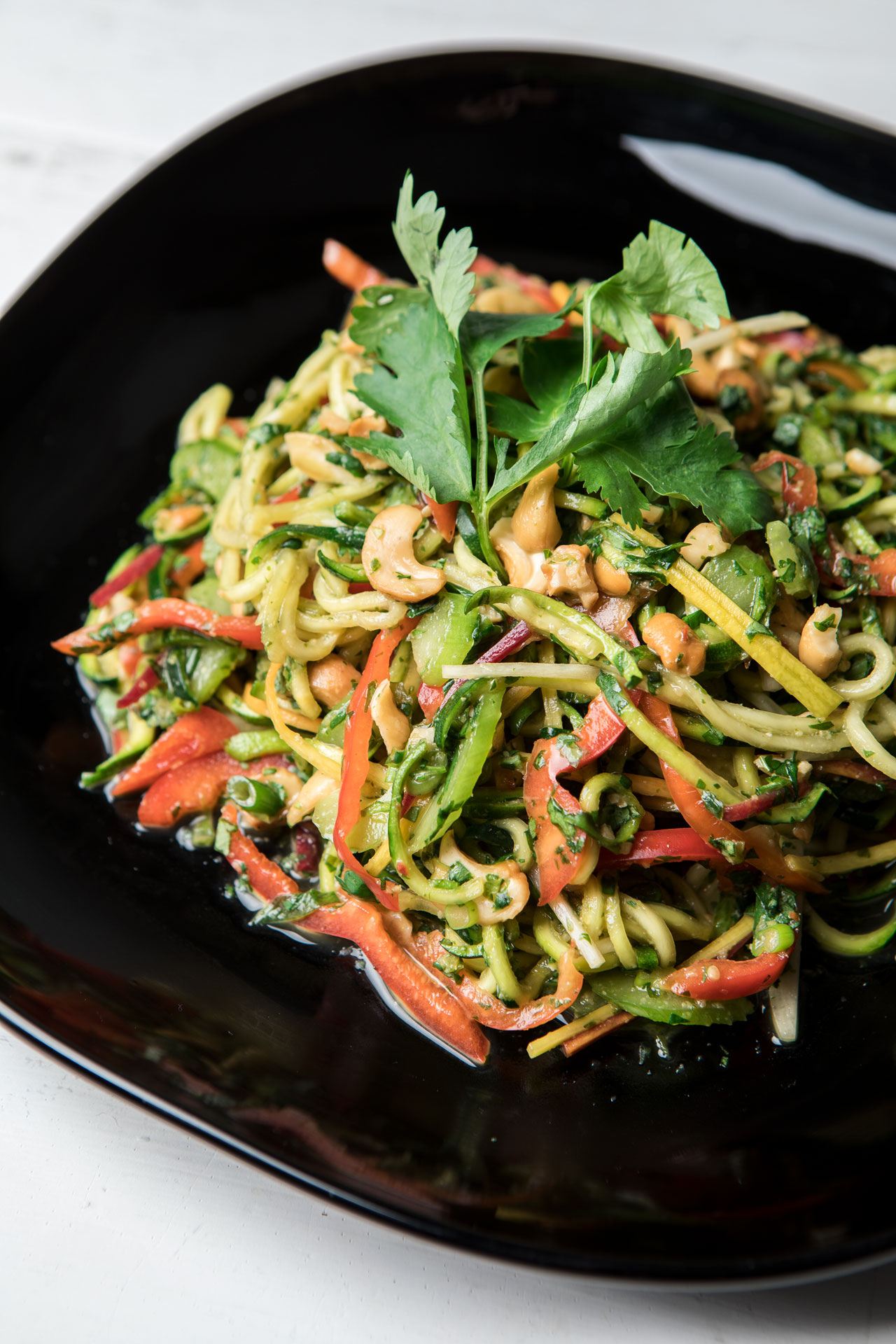 thai zoodle salad on a black plate