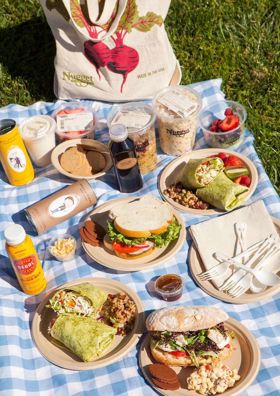 Deli items on a picnic blanket