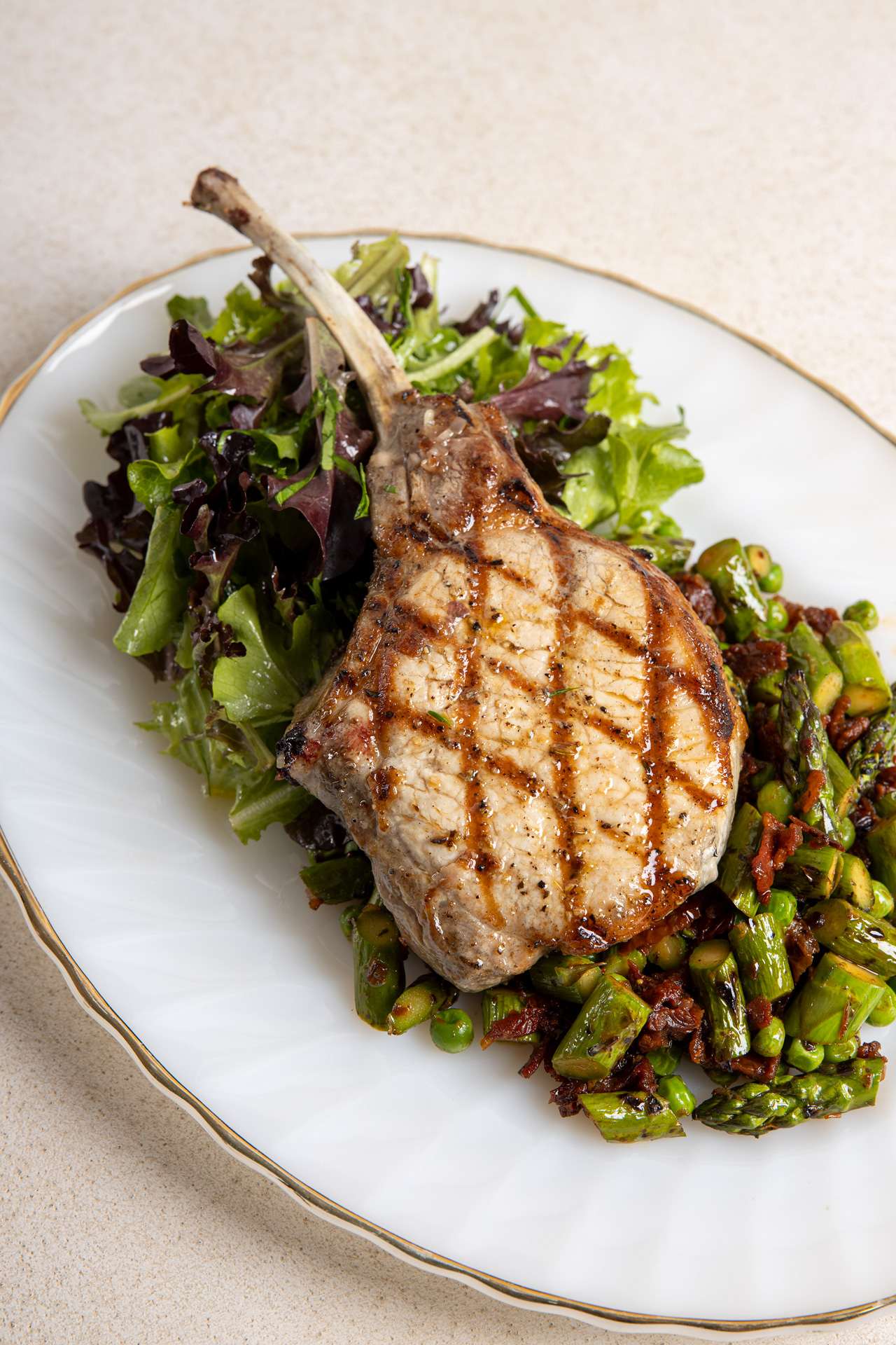 Grilled Tomahawk Pork Chops with Asparagus & Sun-Dried Tomatoes