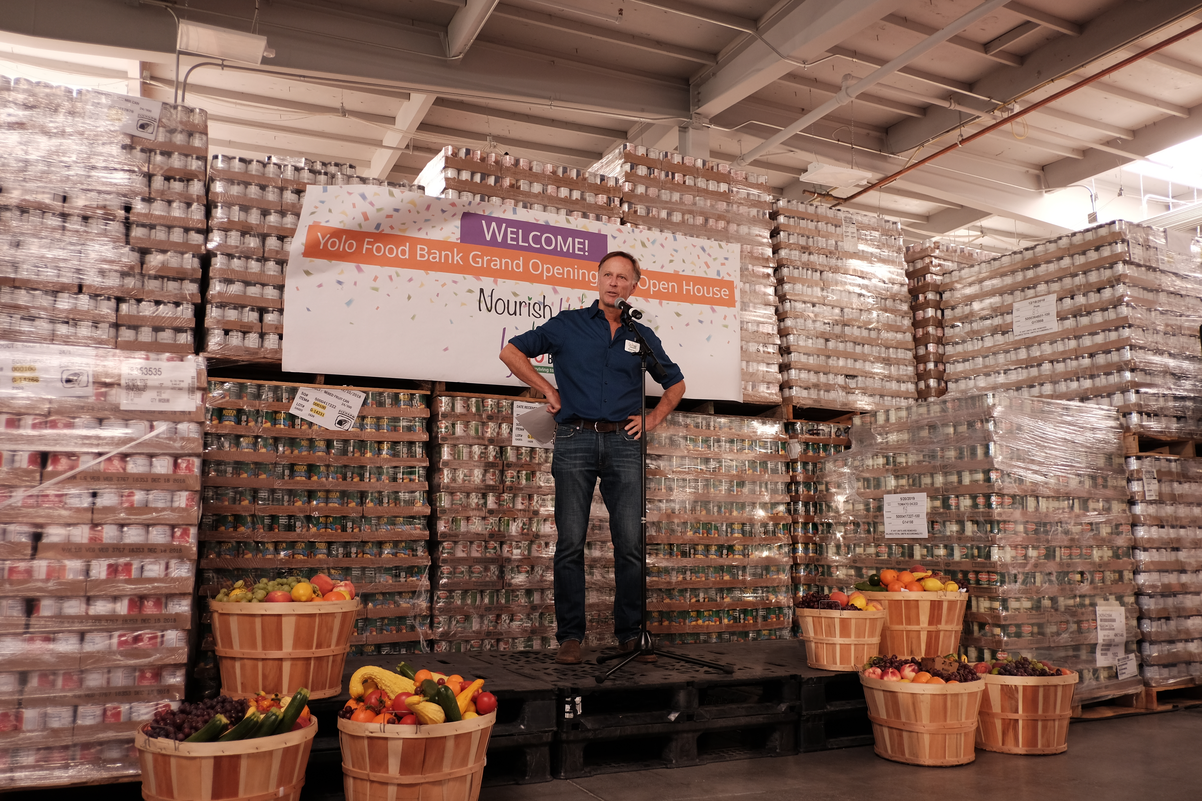 man on stage at yolo food bank warehouse