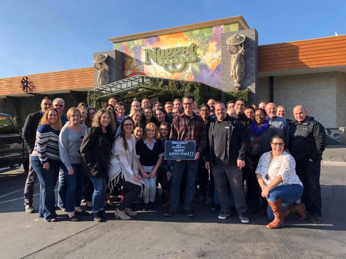 corporate office associates standing with mark outside nugget markets woodland